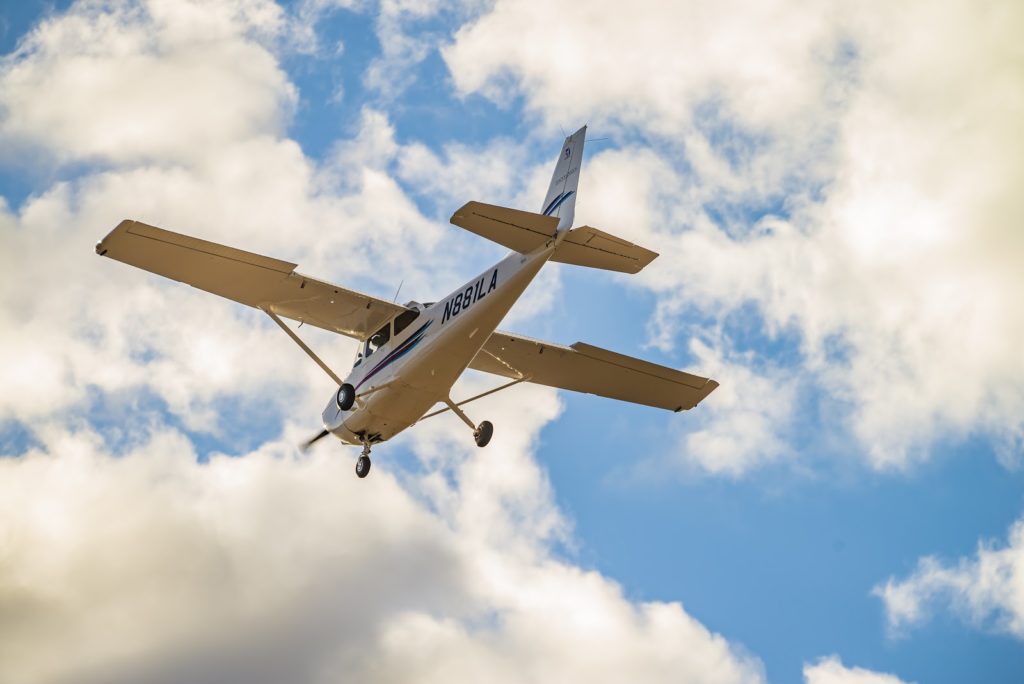 Ground view of plane in sky 