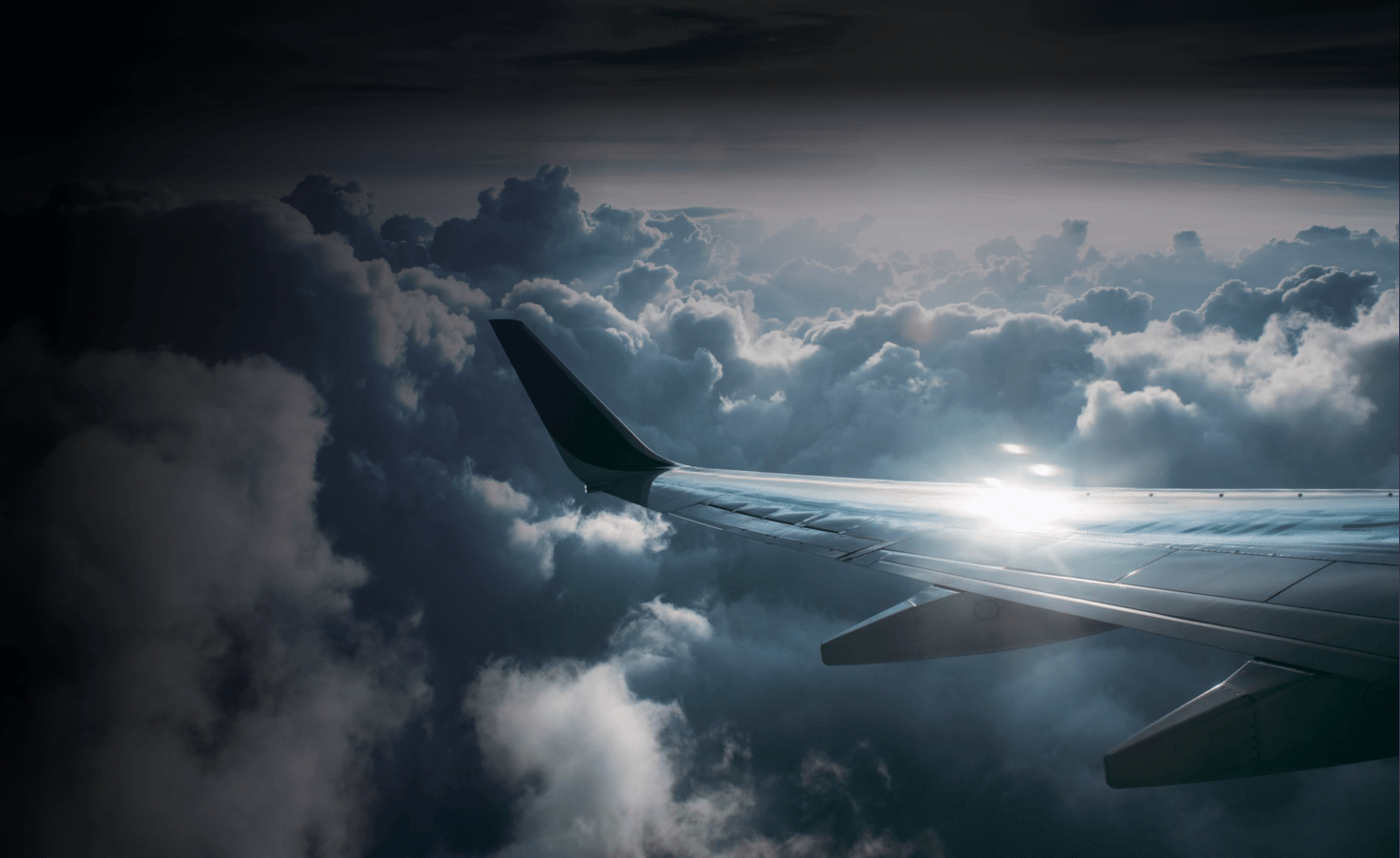 an aircraft flying in a brightly lit sky